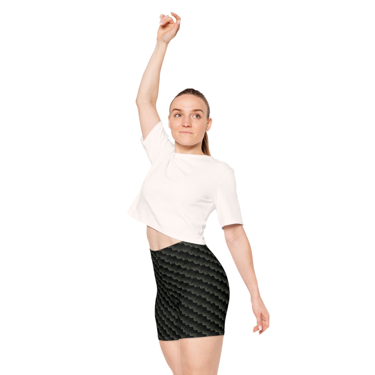 Black with abstract sage pattern athletic shorts modeled by female wearing cropped white shirt with right hand raised high. These biker shorts make great gifts for women who love comfortable, stylish activewear.