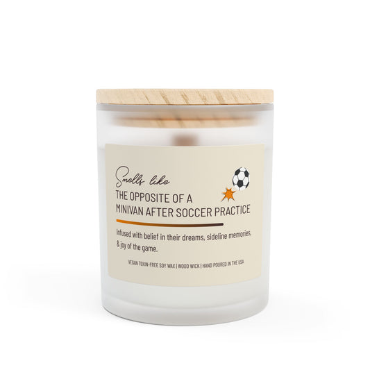 Frosted glass candle with wooden lid, labeled "Smells like the opposite of a minivan after soccer practice," featuring a small soccer ball graphic. This funny candle makes a great gift for women.
