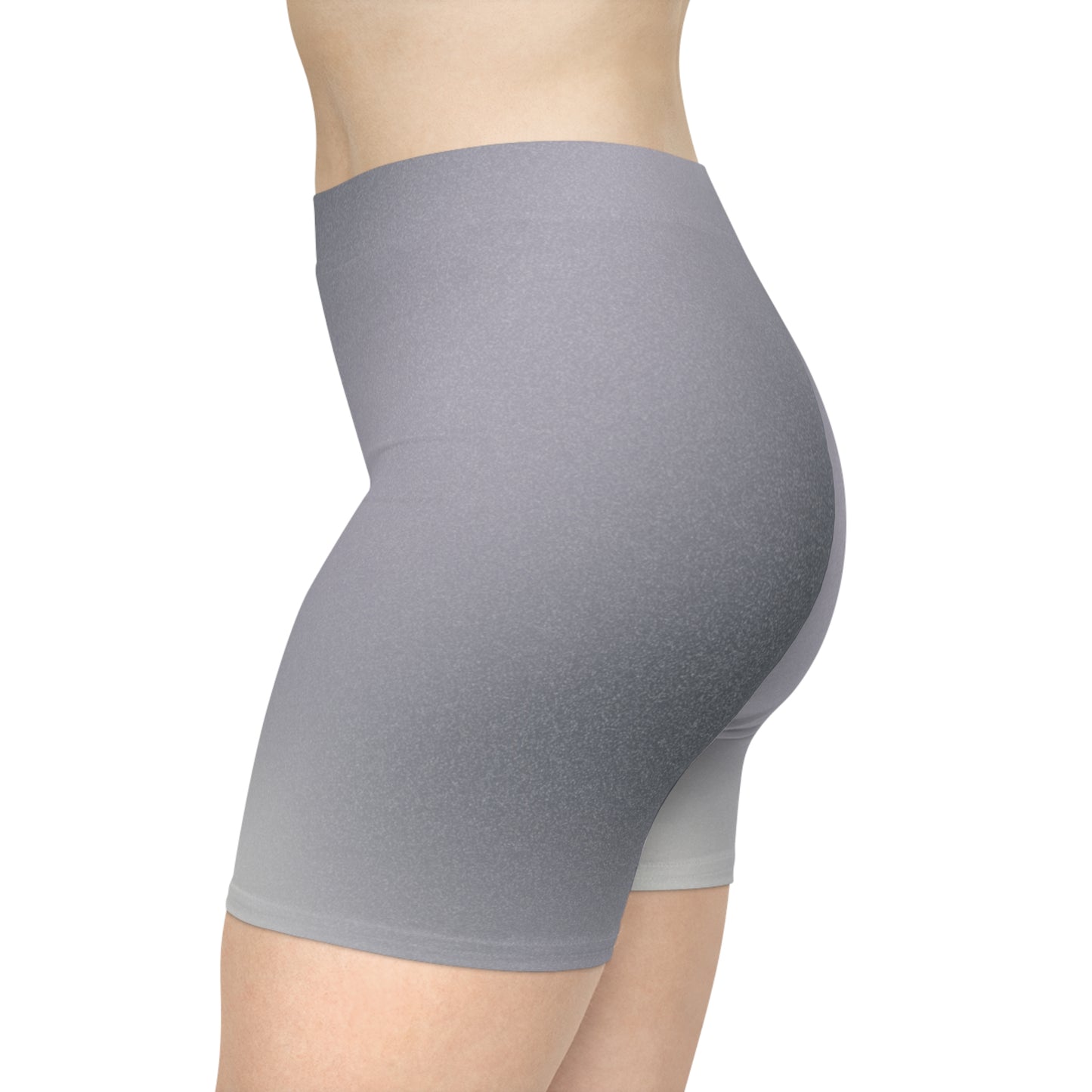 Left side view of a female wearing high-waisted gray ombre shorts, blending from dark to light gray. The pose showcases the shorts' snug fit and non-linear gradient design. These shorts make great gifts for women who love activewear.