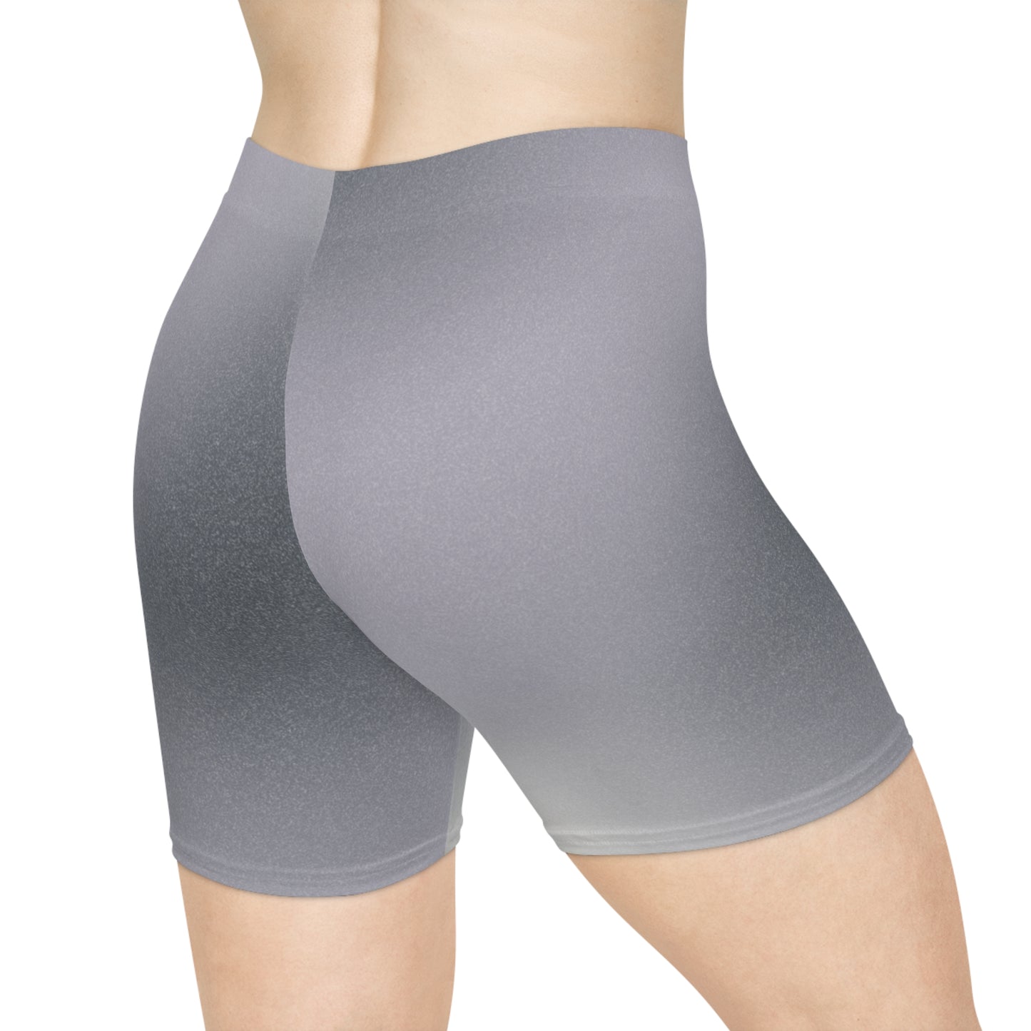 Back view of a female wearing high-waisted gray ombre shorts, blending from dark to light gray. The pose showcases the shorts' snug fit and non-linear gradient design. These shorts make great gifts for women who love activewear.