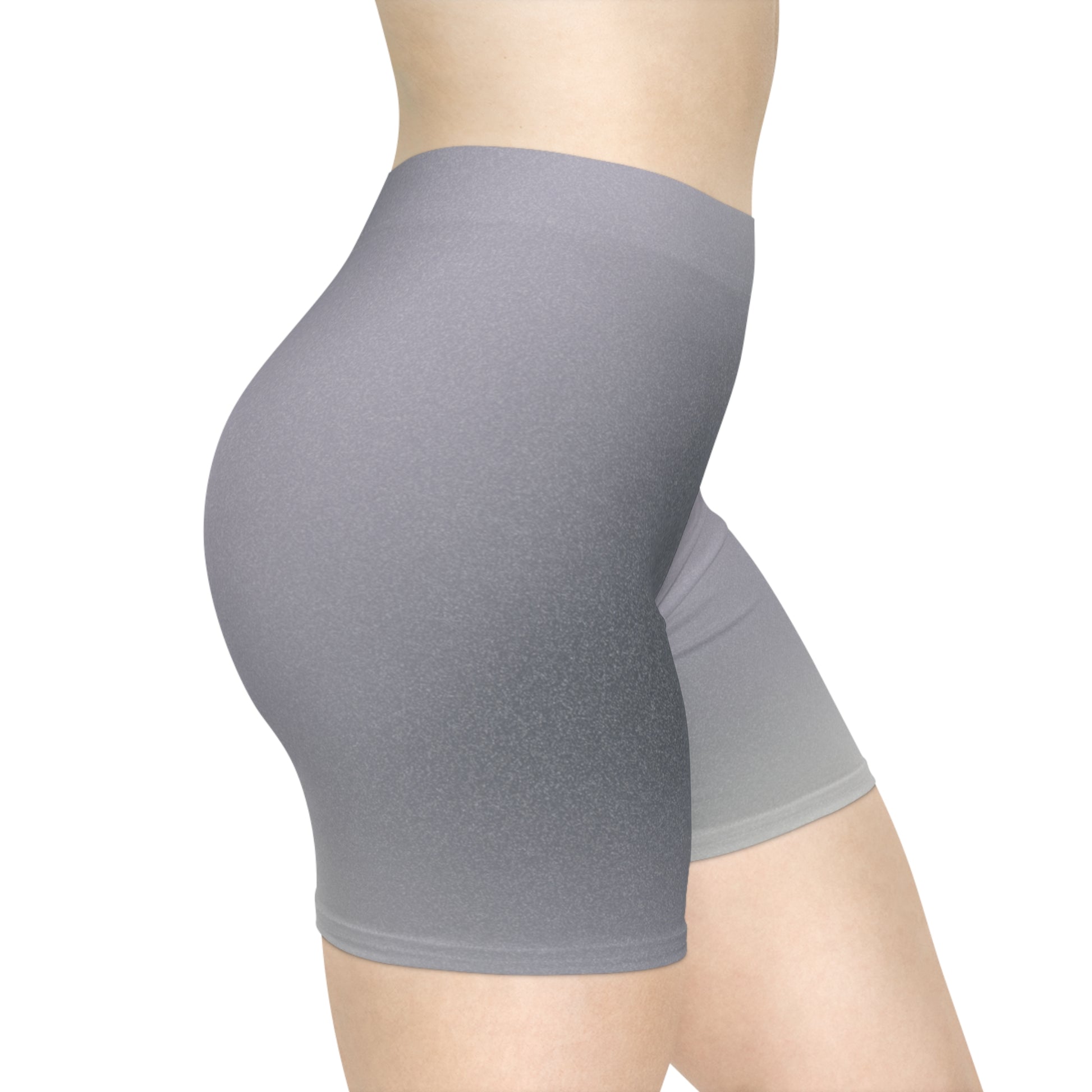 Right side view of a female wearing high-waisted gray ombre shorts, blending from dark to light gray. The pose showcases the shorts' snug fit and non-linear gradient design. These shorts make great gifts for women who love activewear.