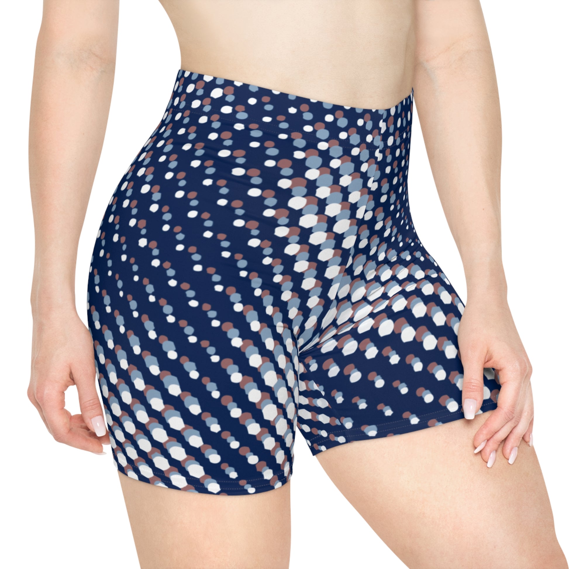 Woman wearing dark blue biker shorts with a white circular pattern. She stands against a white background. These biker shorts make great gifts for women who love stylish casual wear.