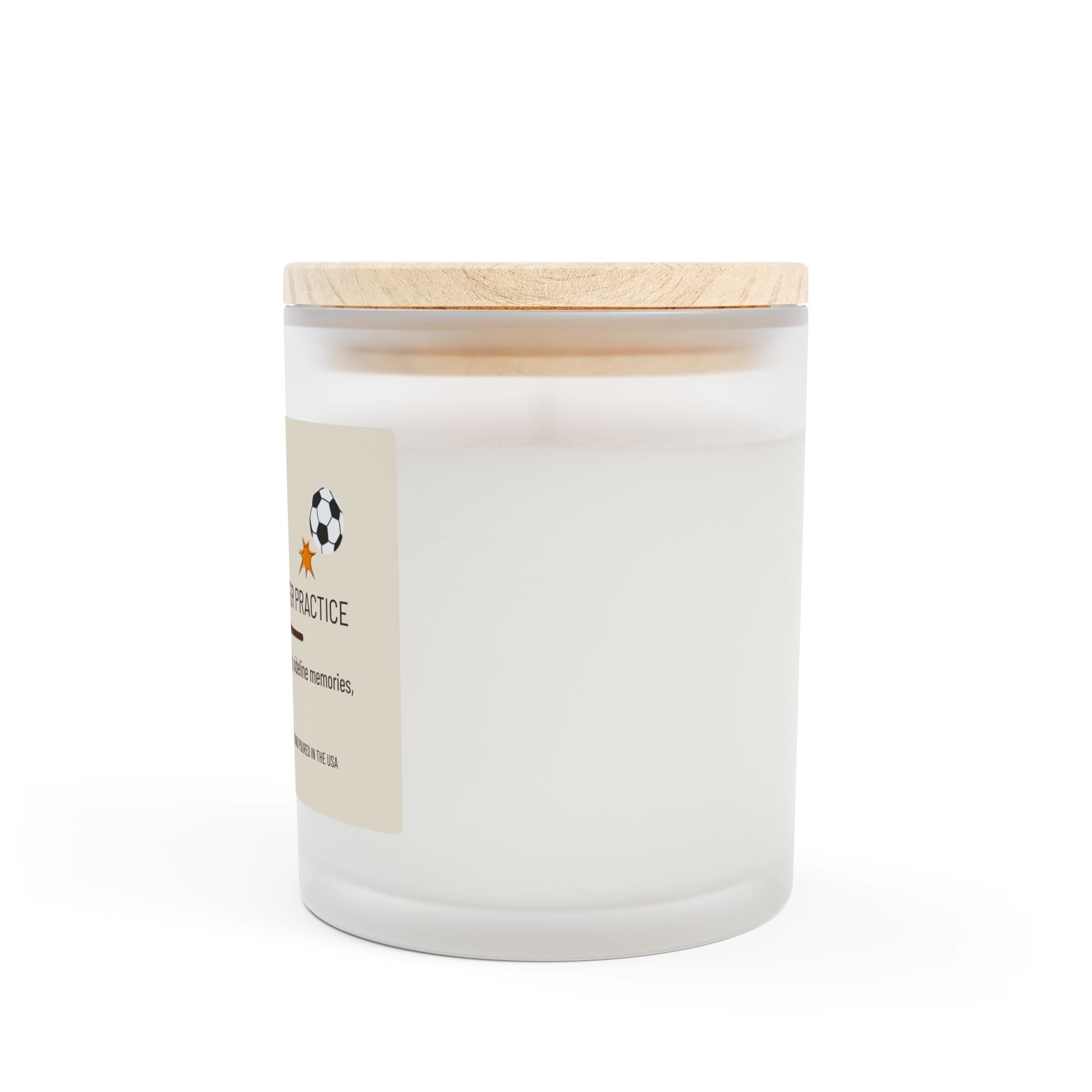 Right side view of frosted glass candle with wooden lid with small part of label showing soccer ball graphic visible. This funny candle makes a great gift for women.