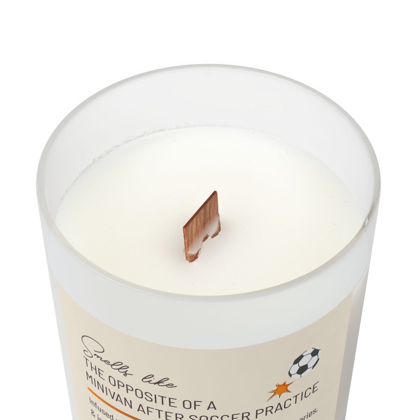 Top view of frosted glass candle showing wooden wick sticking up from the candle and part of the label reading, "Smells like the opposite of a minivan after soccer practice". This funny candle makes a great gift for women