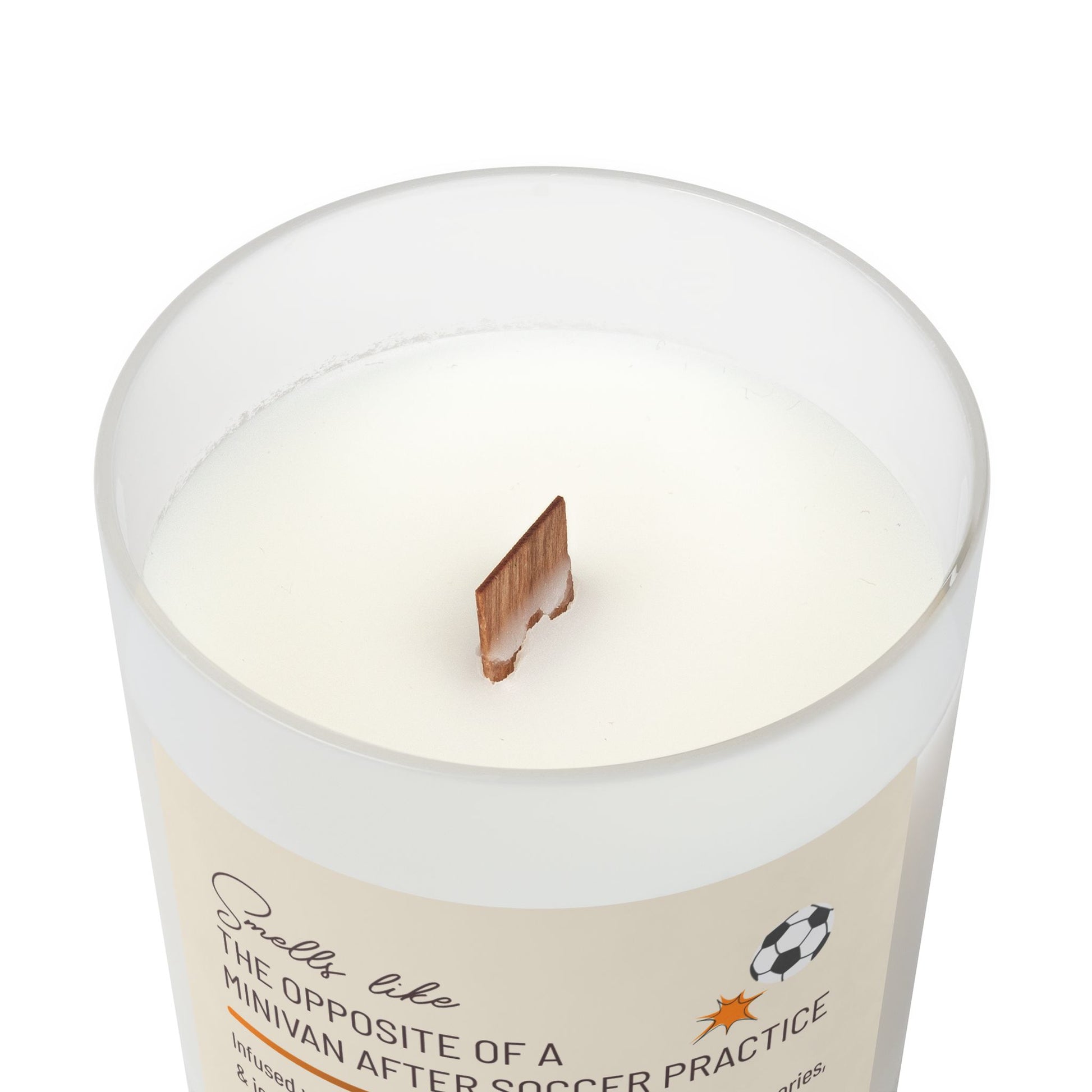 Top view of frosted glass candle showing wooden wick sticking up from the candle and part of the label reading, "Smells like the opposite of a minivan after soccer practice". This funny candle makes a great gift for women